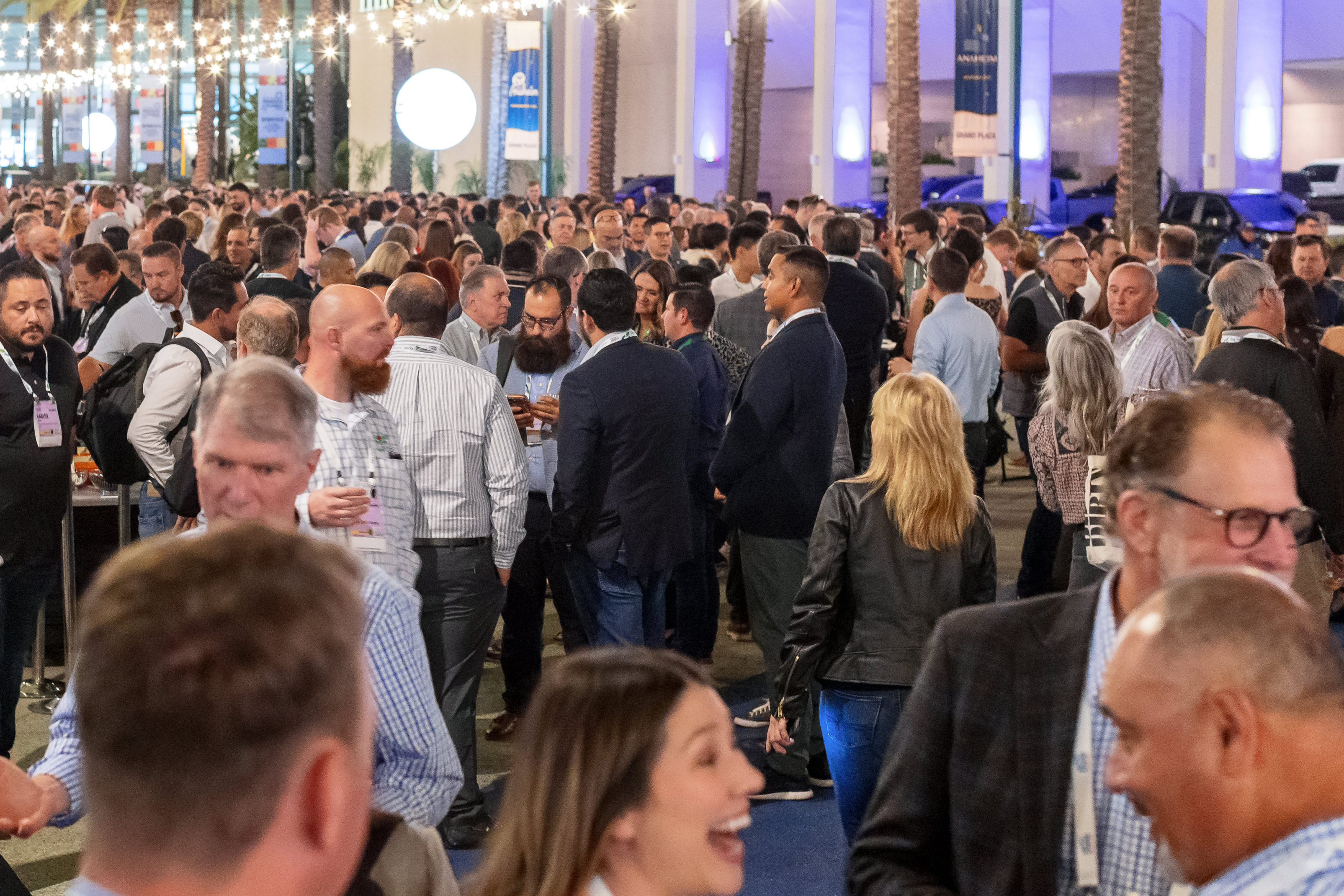 Large crowd of fresh produce and floral industry professionals networking at an evening outdoor reception during the IFPA Global Show