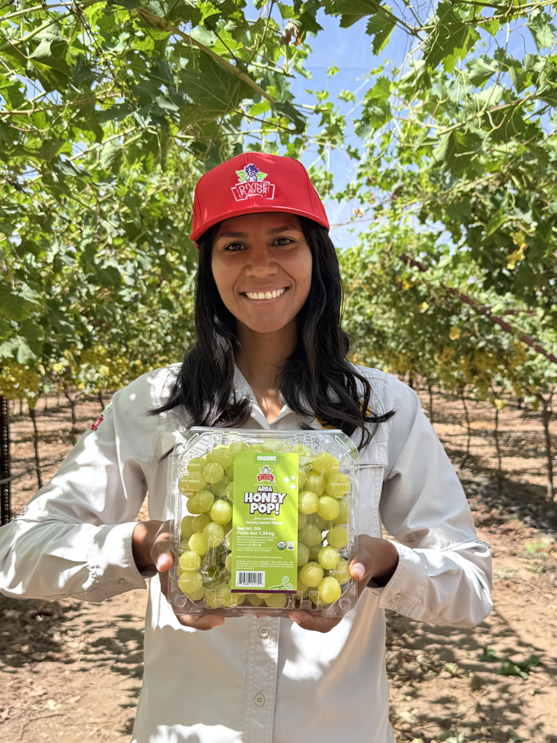 Divine Flavor, holding grapes