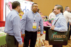 Alfonso Delgado (from left) and Erick Coronado of Avocados from Mexico talk with Juan Estrella, produce merchandiser for Fiesta Mart Inc., during last year’s Viva Fresh event.