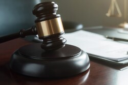 Photo of gavel and file in a courtroom