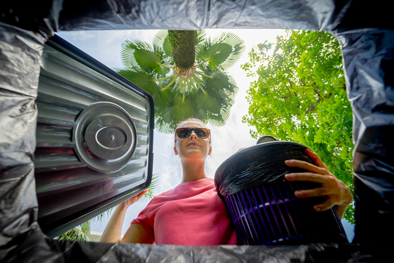 Woman looking into composting bin