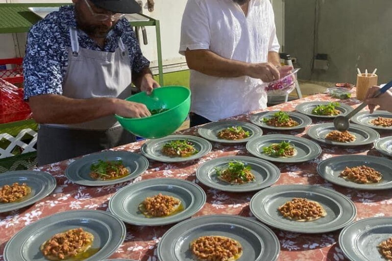 A local chef and Efron David Robles create plates of food.