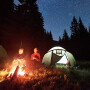 Two people at a campfire