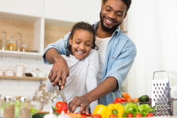 Dad and daughter working in kitchen