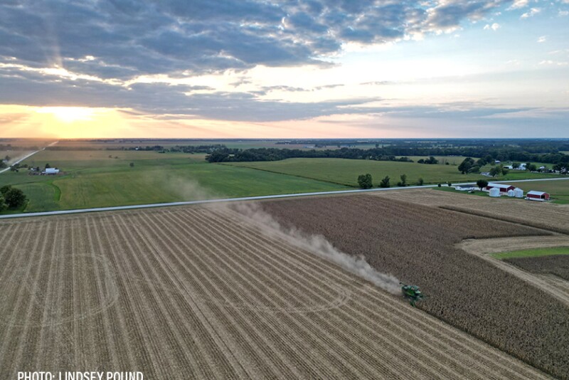 aerial drone photos of corn harvest John Deere combine shelling sunset farmland land - By Lindsey Pound