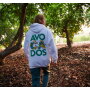 A hoodie from the Commission’s merchandise shop, photographed in a grove. 