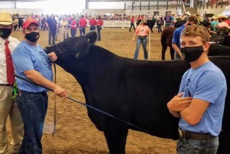 Dan Thomson, professor and chair in the Iowa State Department of Animal Science; Daniel J. Robison, endowed dean's chair in the Iowa State College of Agriculture and Life Sciences; Carson Suchan, youth exhibitor and Webster County 4-H member.