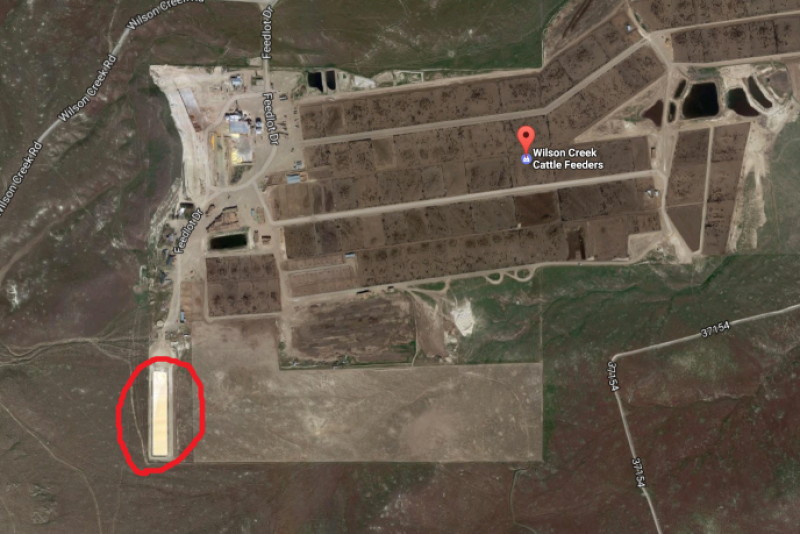 A view of the waste water pit at Wilson Creek Cattle Feeders via Google Maps circled in red.