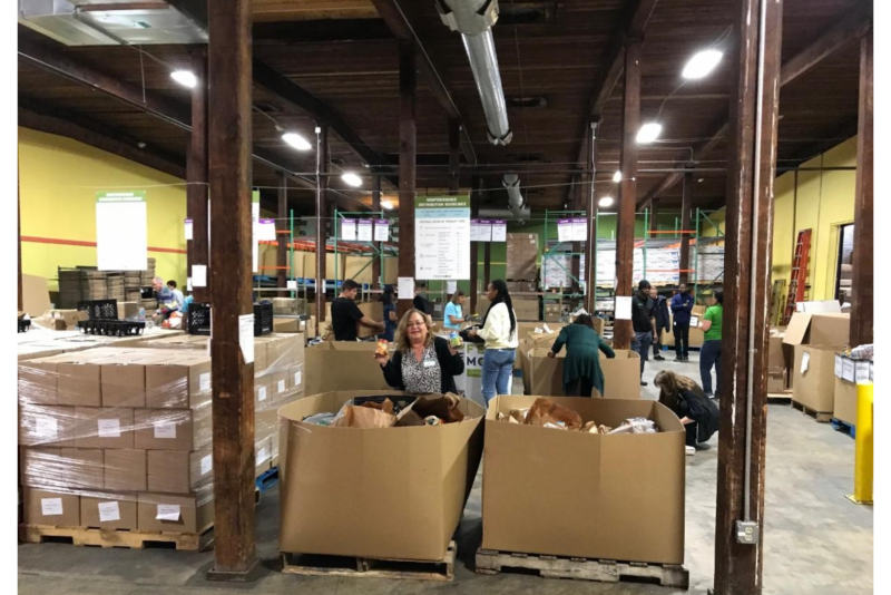 Allen Lund Co. employees help package food for Feedmore in Richmond, Va.
