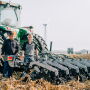 Raymond (left) and Raymond Claire (right) of Zimmerman Manufacturing stand with their strip-till machine.