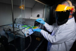 Jacek Koziel adjusts infrared lamps and sensors in a Sukup Hall laboratory. Experiments on infrared light shows that it’s capable of mitigating the spread of the virus that causes porcine reproductive and respiratory syndrome. 

