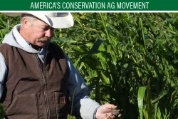 Doug Sieck examines soil from his crop field during a field day at his farm near Selby, S.D. Sieck said deep-rooted cover crops have helped build carbon in his soil, making it capable of handling water in wet years.