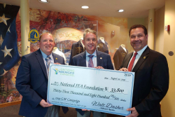 Walt Dasher, center, presents a check to the Future Farmers of American organization.