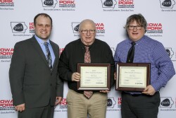  (l to r) Ben Schmaling, president of the Iowa Purebred Swine Council, presents the 2019 Master Seedstock Award to Bill Owens and Bob Owens.
