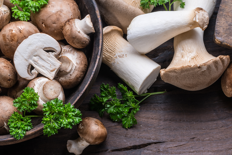 Mushrooms in a bowl and on a counter