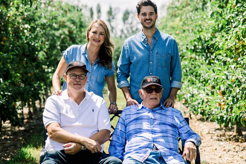 Hudson River Fruit Distributors leadership gathered in an orchard