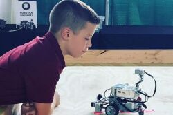Hunter looking at robot
