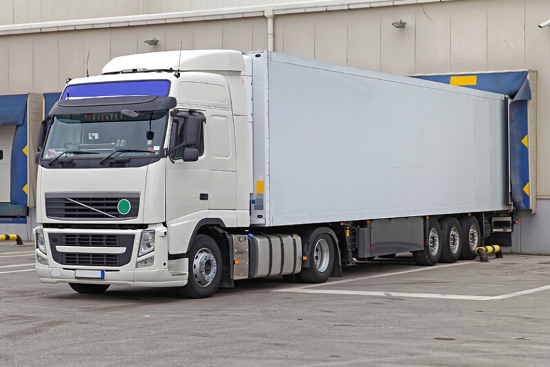 Cooler truck at warehouse loading bay