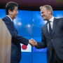 Shinzo Abe, Japan's prime minister, left, greets Donald Tusk, president of the European Union, ahead of a news conference at the European Council in Brussels, Belgium, on March 21, 2017.