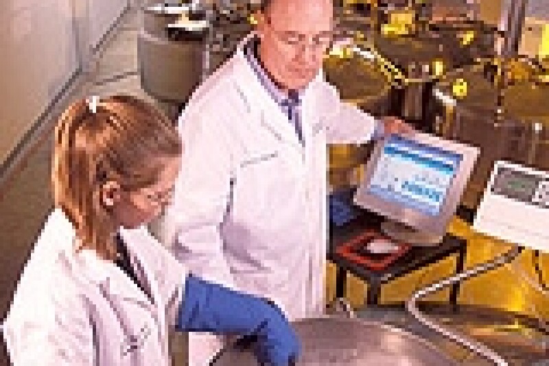 National Animal Germplasm Program coordinator Harvey Blackburn and technician Ginny Schmit place germplasm samples into a liquid nitrogen tank for long-term storage.
