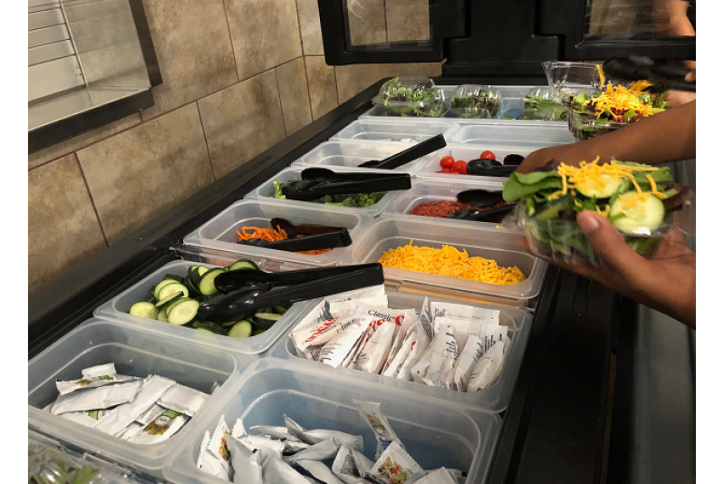 Students at Faith Family Academy-Oak Cliff enjoy from produce from a salad bar donated by the Dallas Fresh Food Association in May.