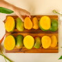 Halved mangoes on a serving tray