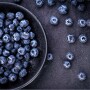 Blueberries in a bowl and on a table