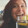 woman holding mason jar of water with lemon wedges in it