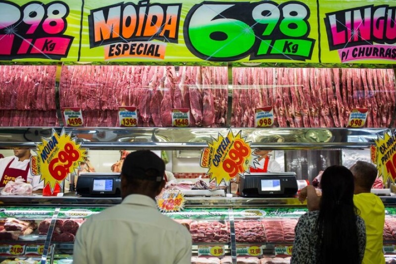 Customers buy meat from at a butchery stall inside a market in Sao Paulo, Brazil, on Saturday, March 18, 2017.