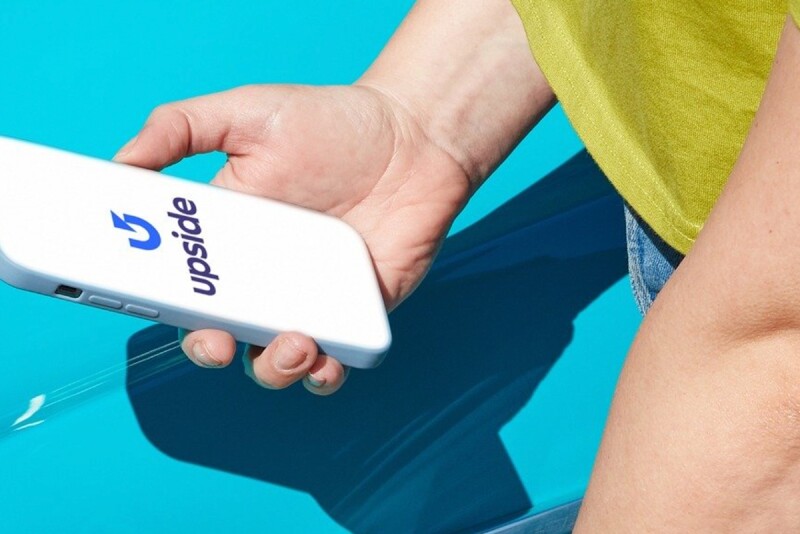Person holding smartphone with Upside on the screen