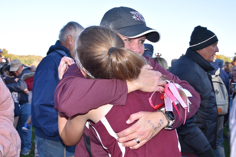 Olivia Shike and Coach Kara Leaman after State Cross Country Meet