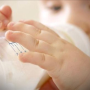Child drinks from baby bottle