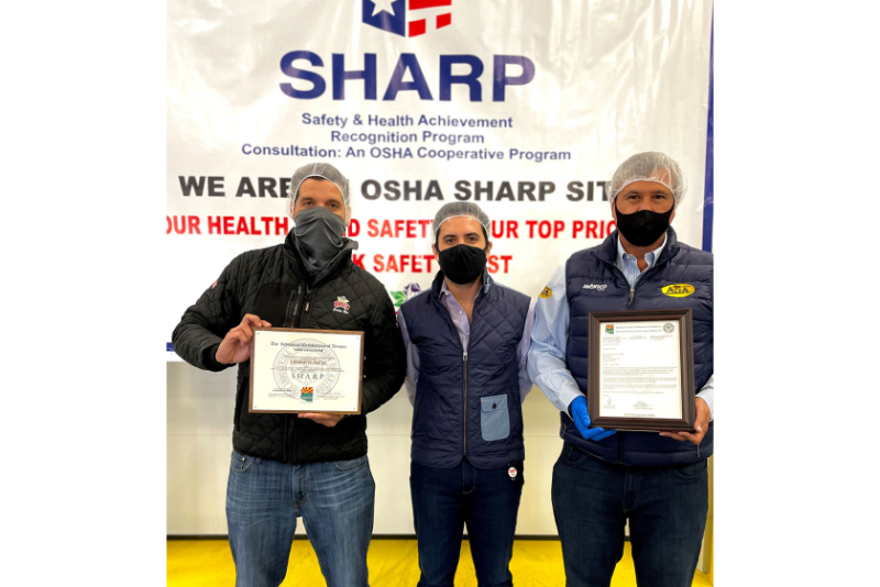 Carlos Bon (from left), vice president of sales at Divine Flavor; Jose Antonio Martinez, general manager; and Alan Aguirre, president and CEO, at a ceremony celebrating the company's health and safety management systems.