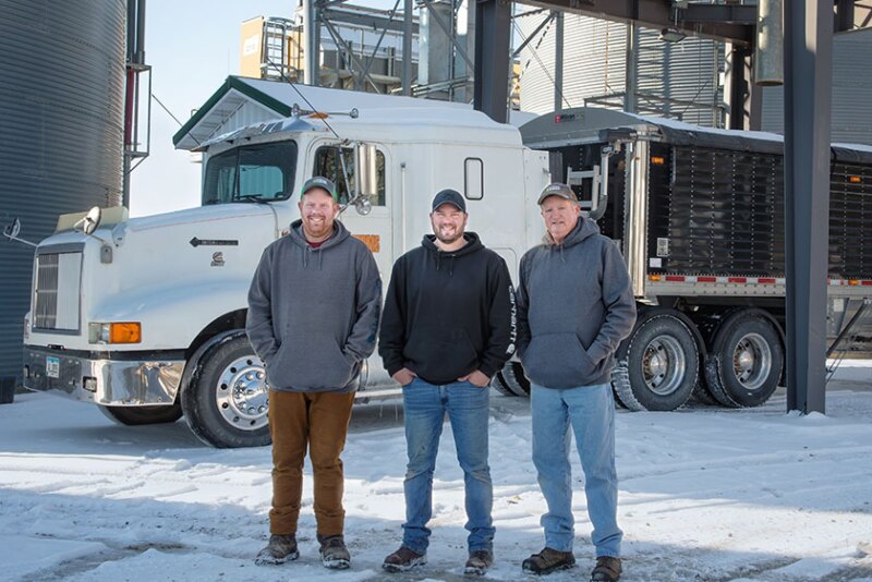 From left, brothers Andrew and Philip Hanna are combining their individual Iowa farm operations with their father, Mark. 