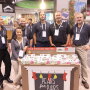 Representatives of Rainier Fruit Co. show off a retail display for the company’s Pears for Pairs promo during Fresh Summit 2019