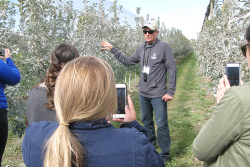 Neal Carter, founder and president of Okanagan Specialty Fruit, leads a tour at an orchard of Arctic apples last October. The company invited produce industry media, bloggers and food writers to explain how the genetically engineered apples were developed, and to talk about plans for increased production.