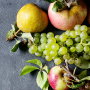 Overhead view of a cluster of pears, apples and red and green grapes