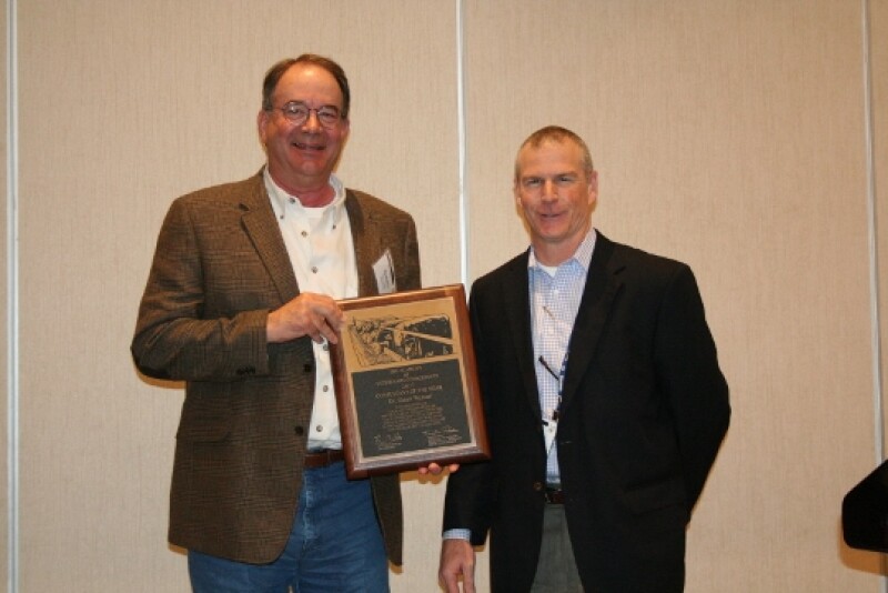 Zoetis technical-services veterinarian Mitch Blanding (right) presents Dr. Weaver with the Consultant of the Year Award.