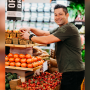 Retail produce clerk working with organic produce