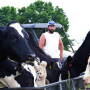 In this photo taken May 17, 2017, Ben Seaton, 21, stands on his family's dairy farm in Debusk, Tenn. Seaton takes pride in the cows he has bred and now milks each day on the farm.
