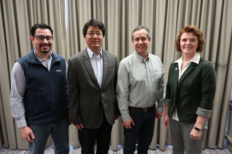 L to R: Edison Magalhaes, Jianqiang Zhang and Cesar Corzo with Lisa Tokach at the AASV Annual Meeting in Atlanta, Ga. 