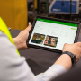 A person using a smart tablet with AgroFresh's FreshCloud digital platform