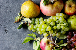 Overhead view of a cluster of pears, apples and red and green grapes