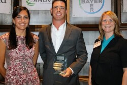 Cody Goodknight, a Chattanooga, Okla., cattle producer and row-crop farmer, accepts the 2017 Tomorrow’s Top Producer Horizon Award from DuPont Pioneer Marketing Communications Manager Katie Meyer (left) and Top Producer Editor Sara Schafer.
