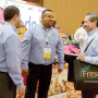Alfonso Delgado (from left) and Erick Coronado of Avocados from Mexico talk with Juan Estrella, produce merchandiser for Fiesta Mart Inc., during last year’s Viva Fresh event.