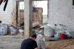 Farmer examines damaged barn