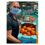 Oppy senior sales representative James Galindo displays Oceanside Pole tomatoes.