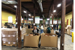 Allen Lund Co. employees help package food for Feedmore in Richmond, Va.