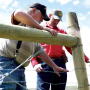 Karl Lankford tests the tension of his new wildlife-friendly fence on May 15, 2017 as Wyoming Game and Fish Senior Game Warden Bill Brinegar talks with him about how the new fence will reduce the number of elk, deer and antelope affected by the barrier.