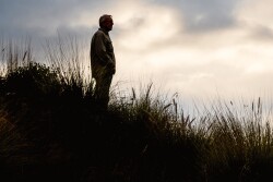 Farmer standing in field mental health